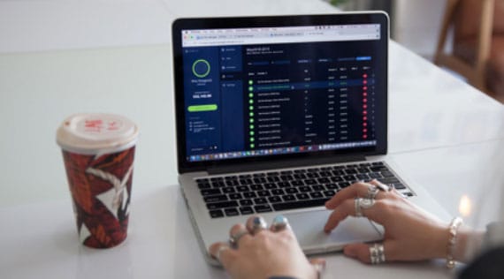 A woman's hands typing on a laptop