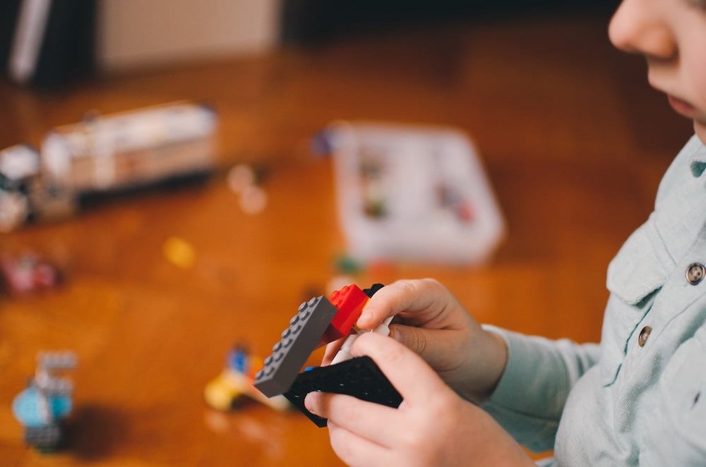 A child playing with lego. 