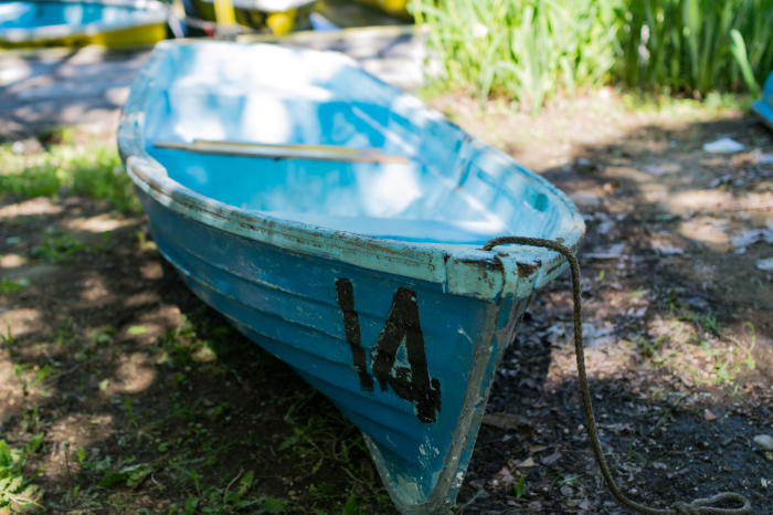The number fourteen painted on a blue boat.