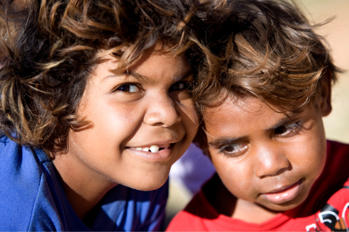 A headshot of two children smiling.