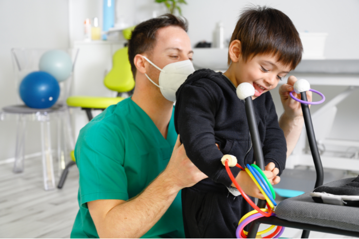A young boy in a physiotherapy session,