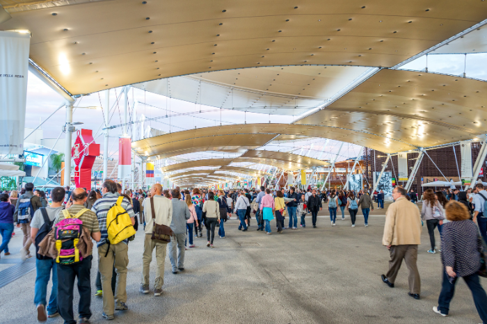 Hundreds of visitors entering an expo.