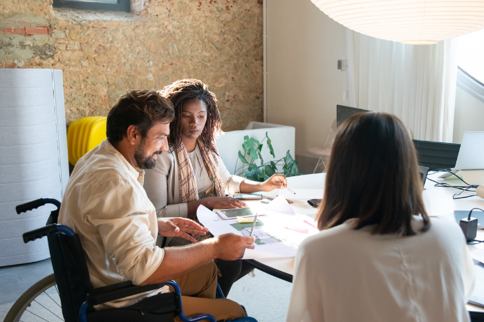 A man in a wheelchair looking at paperwork.