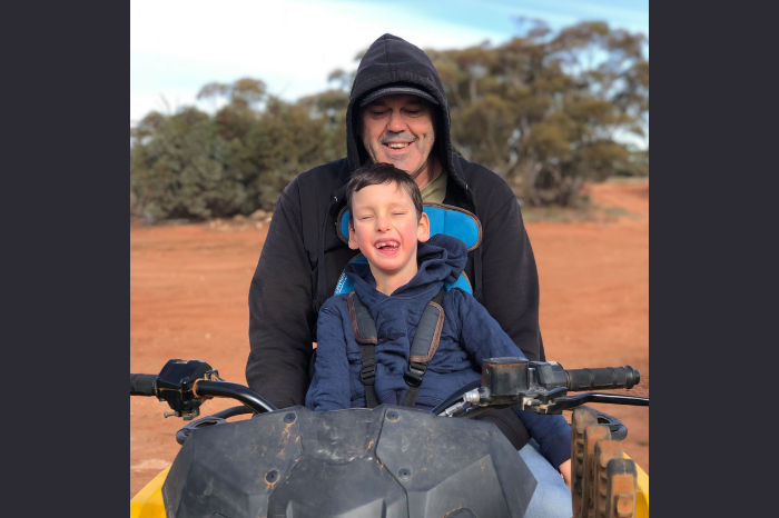 Ben and his son quadbiking.