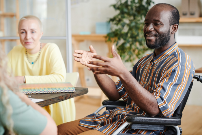A person in a wheelchair speaking confidently.