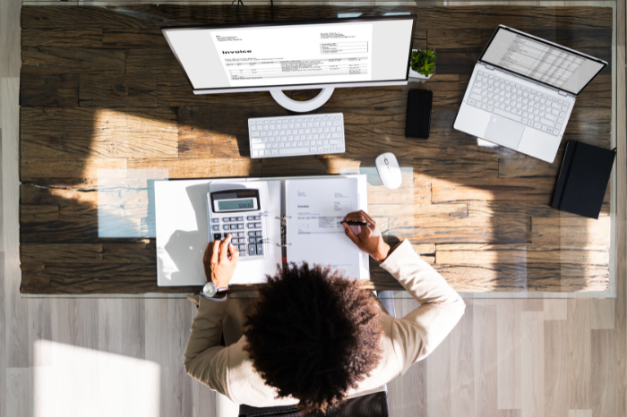 A person creating invoices at their desk.