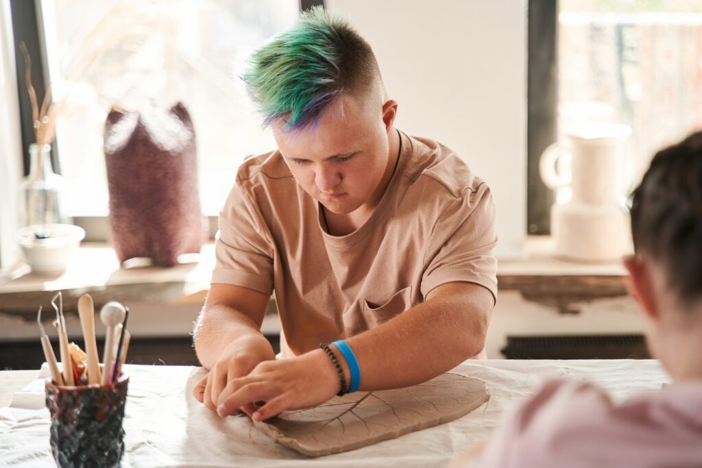 A person looking down doing clay work.