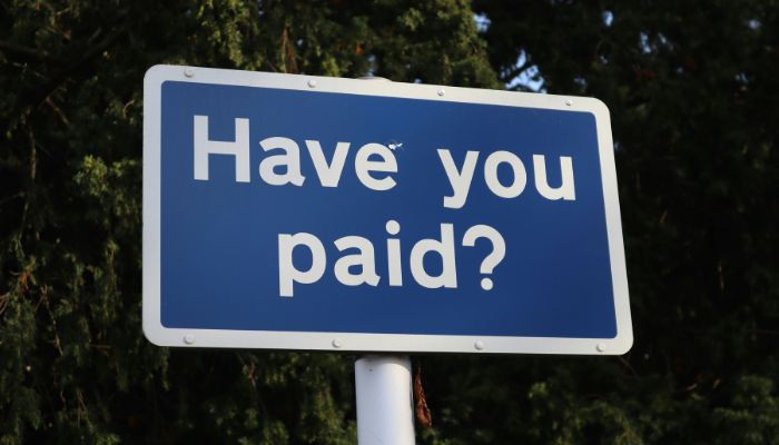 A street sign that reads 'Have you paid?'